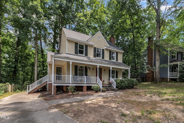 350 Amherst Creek Dr, Wake Forest, NC 27587 - view of front of house with covered porch, a chimney, and roof with shingles