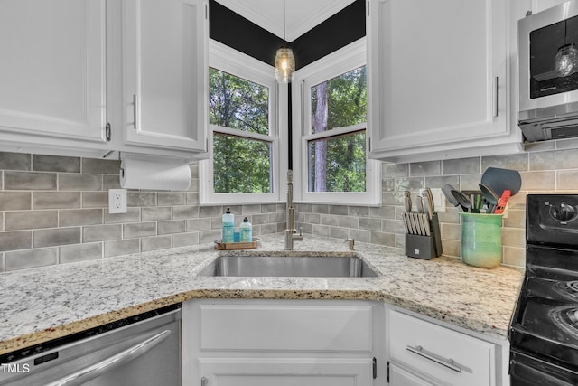 350 Amherst Creek Dr, Wake Forest, NC 27587 - kitchen featuring appliances with stainless steel finishes, white cabinetry, and tasteful backsplash
