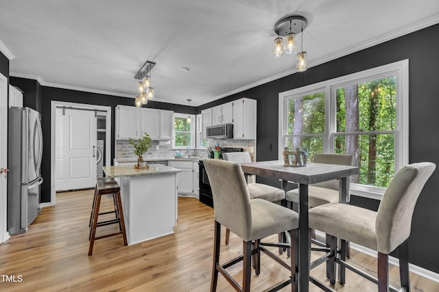 350 Amherst Creek Dr, Wake Forest, NC 27587 - dining room with light wood-style flooring, crown molding, a chandelier, and washer / clothes dryer