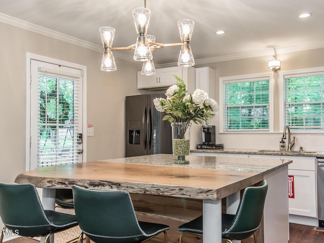3009 Omah St, Durham, NC 27705 - kitchen with stainless steel fridge with ice dispenser, crown molding, light stone countertops, decorative backsplash, and white cabinets