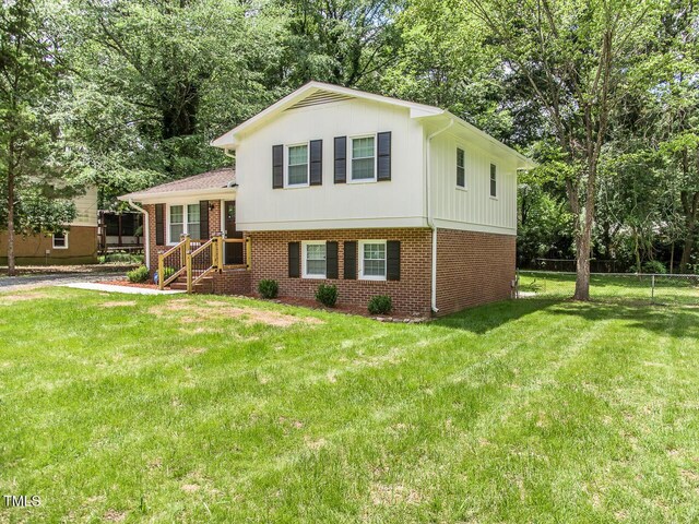 3009 Omah St, Durham, NC 27705 - tri-level home featuring brick siding and view of wooded area