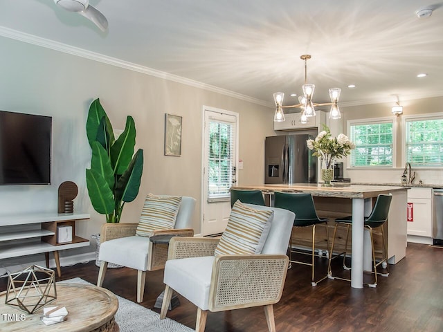 3009 Omah St, Durham, NC 27705 - living area featuring healthy amount of natural light, ornamental molding, dark wood finished floors, and a chandelier