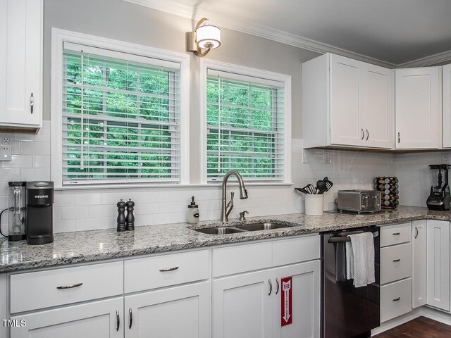 3009 Omah St, Durham, NC 27705 - kitchen with dishwashing machine, crown molding, backsplash, white cabinets, and light stone counters