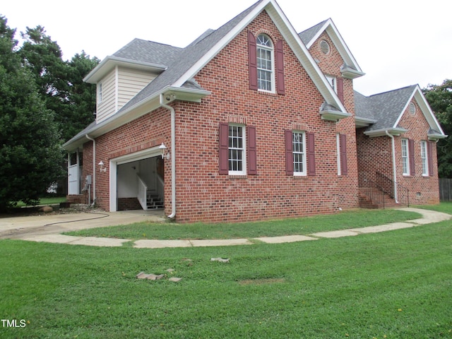 4817 Tupenny Ln, Raleigh, NC 27606 - view of home's exterior featuring brick siding, roof with shingles, driveway, and a yard
