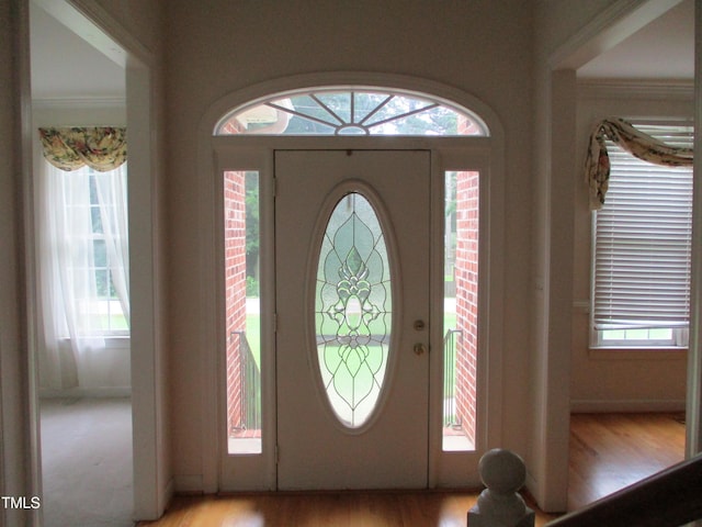 4817 Tupenny Ln, Raleigh, NC 27606 - entrance foyer featuring light wood-type flooring, healthy amount of natural light, and ornamental molding