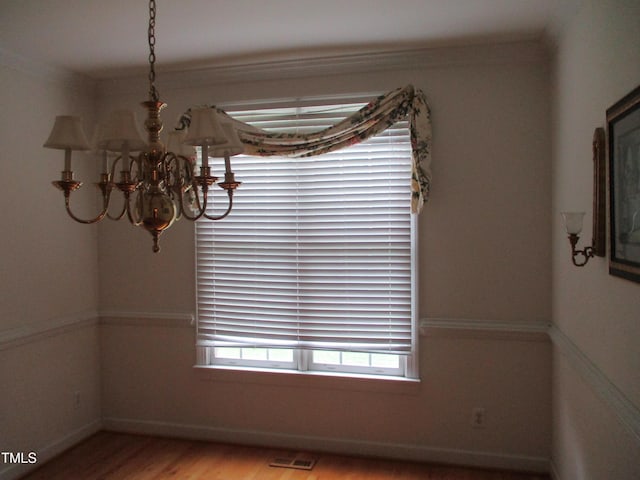 4817 Tupenny Ln, Raleigh, NC 27606 - unfurnished dining area featuring a chandelier and wood finished floors