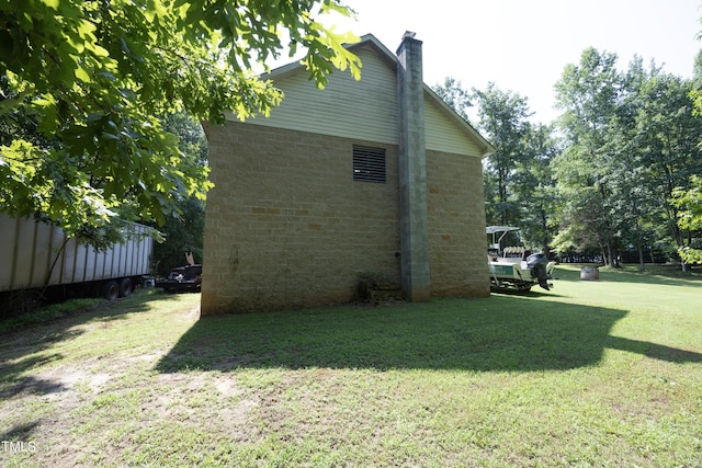 205 N Raleigh Farms Rd, Youngsville, NC 27596 - view of property exterior featuring a lawn, a chimney, and stone siding