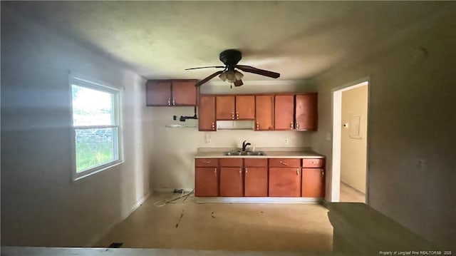 1034CRAYTONCIRCLE Crayton Cir, Fayetteville, NC 28314 - kitchen featuring a ceiling fan, brown cabinets, and light countertops