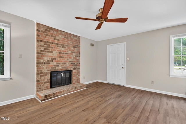 10 Tarawa Ter, Durham, NC 27705 - unfurnished living room featuring wood finished floors, a brick fireplace, and ceiling fan