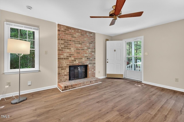 10 Tarawa Ter, Durham, NC 27705 - unfurnished living room featuring wood finished floors, healthy amount of natural light, and a ceiling fan