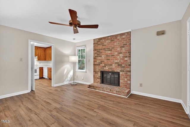 10 Tarawa Ter, Durham, NC 27705 - unfurnished living room featuring wood finished floors, a ceiling fan, and a fireplace