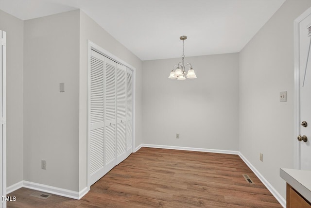 10 Tarawa Ter, Durham, NC 27705 - unfurnished dining area with wood finished floors and a chandelier