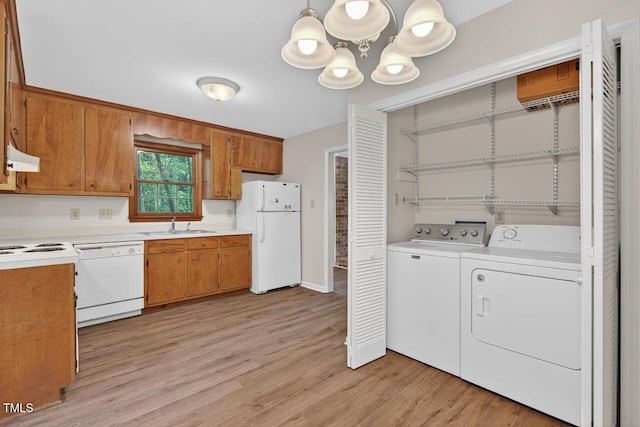 10 Tarawa Ter, Durham, NC 27705 - laundry room featuring a chandelier, light wood-type flooring, and washer and dryer