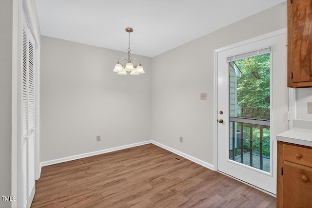 10 Tarawa Ter, Durham, NC 27705 - unfurnished dining area with wood finished floors and a chandelier