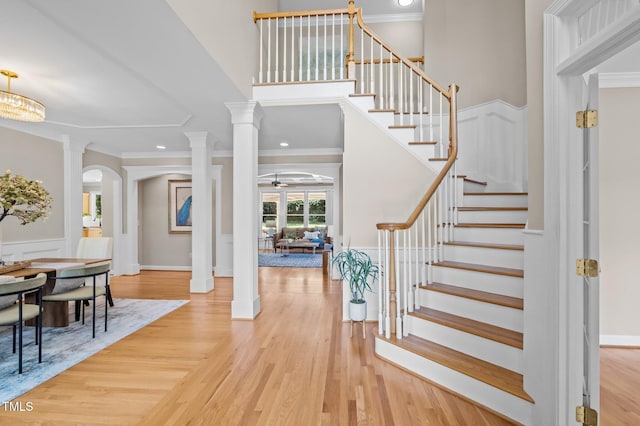 202 Bridewell Ct, Cary, NC 27518 - entrance foyer featuring ornamental molding, arched walkways, stairway, wood finished floors, and ornate columns