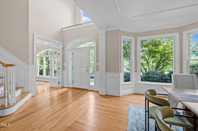 202 Bridewell Ct, Cary, NC 27518 - entryway with stairway, a decorative wall, wainscoting, light wood-style floors, and crown molding