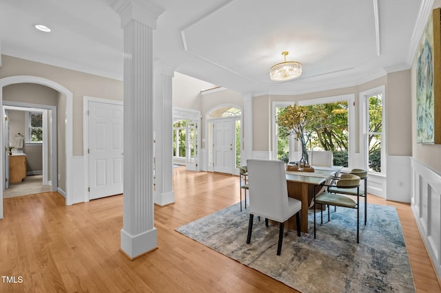 202 Bridewell Ct, Cary, NC 27518 - dining space featuring decorative columns, light wood-type flooring, crown molding, and a chandelier