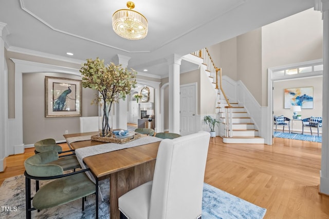 202 Bridewell Ct, Cary, NC 27518 - dining room with ornate columns, stairs, light wood-style floors, wainscoting, and crown molding