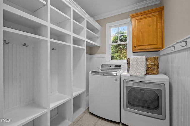 202 Bridewell Ct, Cary, NC 27518 - washroom featuring cabinet space, separate washer and dryer, ornamental molding, and light tile patterned flooring