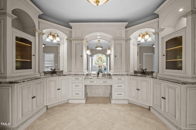 202 Bridewell Ct, Cary, NC 27518 - bathroom with ornate columns, a chandelier, two vanities, and ornamental molding