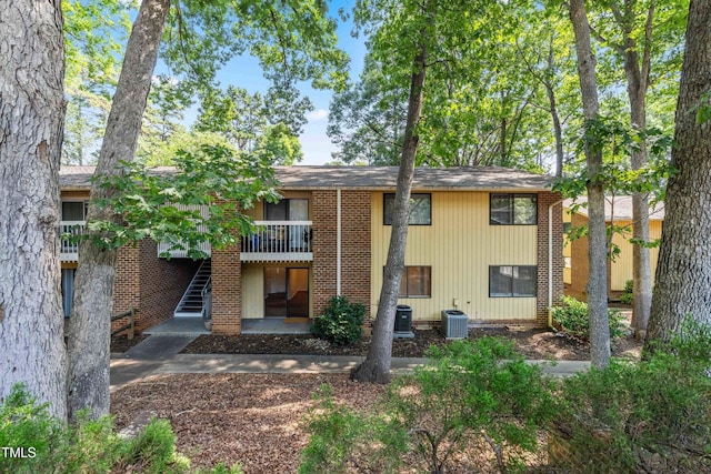 1212 Schaub Dr, Raleigh, NC 27606 - back of property featuring stairway and brick siding