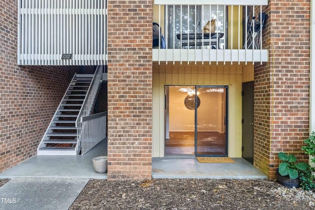 1212 Schaub Dr, Raleigh, NC 27606 - entrance to property with brick siding and a balcony