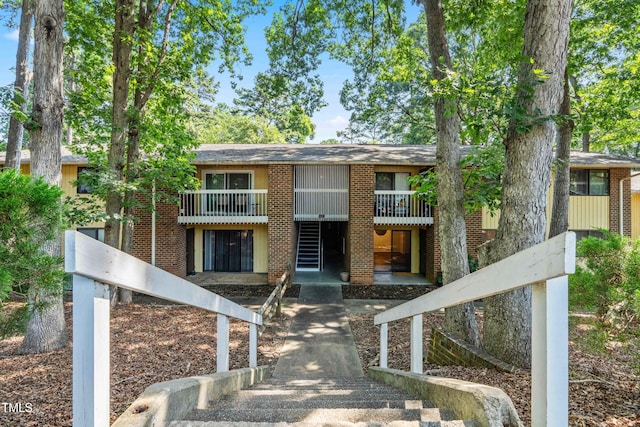 1212 Schaub Dr, Raleigh, NC 27606 - view of front of house featuring a balcony and brick siding