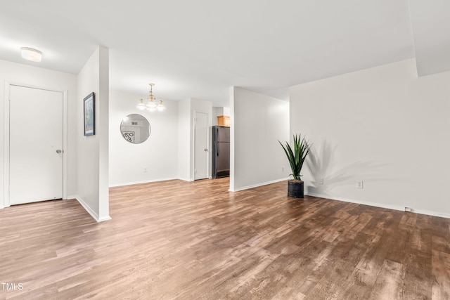 1212 Schaub Dr, Raleigh, NC 27606 - unfurnished room with light wood-style flooring and a chandelier