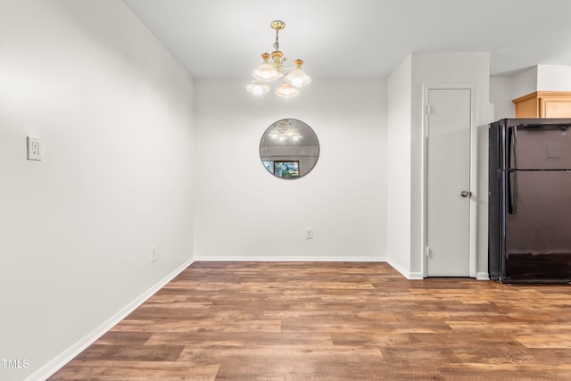 1212 Schaub Dr, Raleigh, NC 27606 - unfurnished dining area with a chandelier and wood finished floors