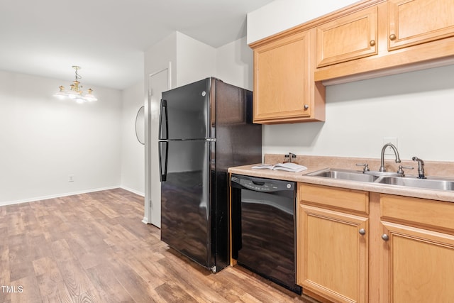 1212 Schaub Dr, Raleigh, NC 27606 - kitchen with black appliances, light brown cabinetry, light wood-style floors, and light countertops