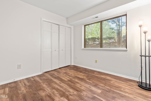 1212 Schaub Dr, Raleigh, NC 27606 - unfurnished bedroom with wood finished floors and a closet