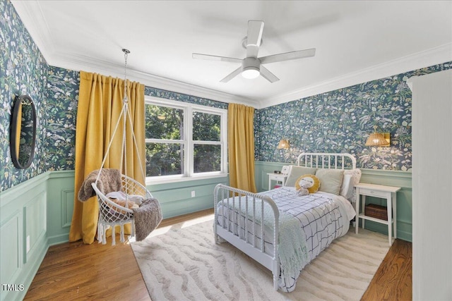 8909 Hunting Trl, Raleigh, NC 27613 - bedroom with wallpapered walls, ornamental molding, wood finished floors, a wainscoted wall, and ceiling fan