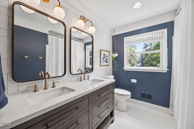 8909 Hunting Trl, Raleigh, NC 27613 - full bathroom featuring crown molding, double vanity, tile patterned floors, and backsplash