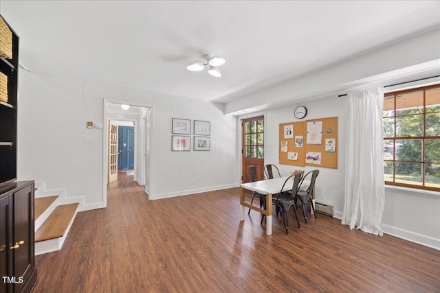 8909 Hunting Trl, Raleigh, NC 27613 - dining area with dark wood-type flooring and a baseboard heating unit