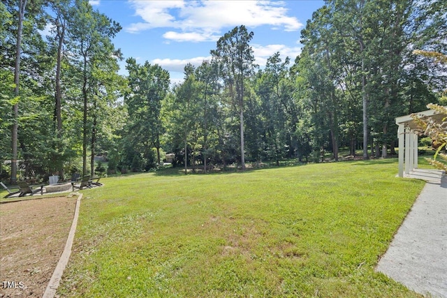 8909 Hunting Trl, Raleigh, NC 27613 - view of green lawn featuring a fire pit