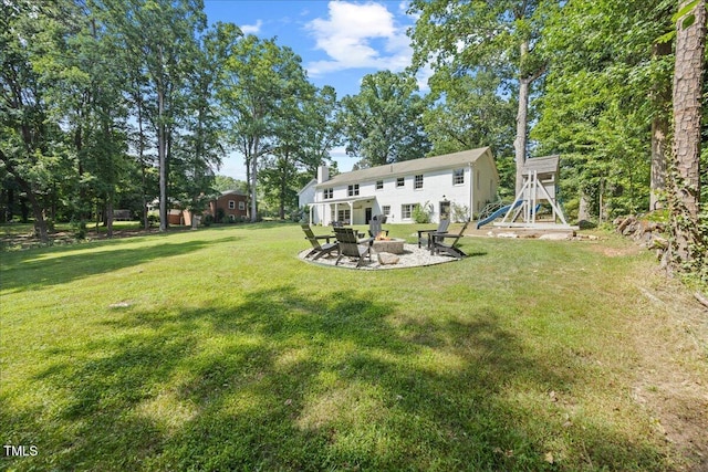 8909 Hunting Trl, Raleigh, NC 27613 - view of green lawn with an outdoor fire pit and a patio area