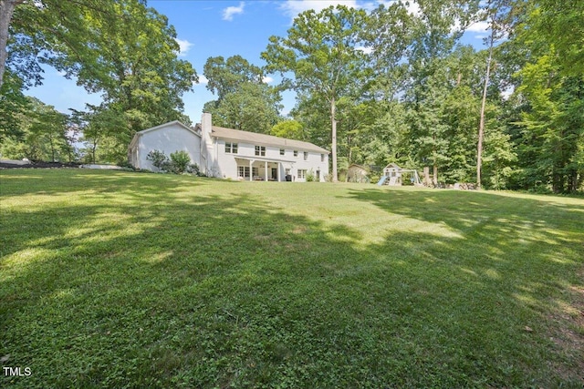 8909 Hunting Trl, Raleigh, NC 27613 - view of grassy yard featuring a playground