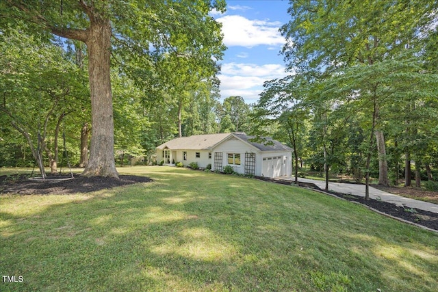 8909 Hunting Trl, Raleigh, NC 27613 - view of front of home with concrete driveway, an attached garage, and a front yard