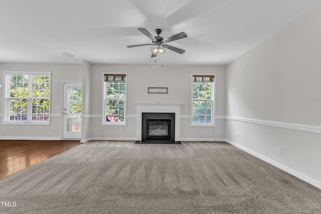 3905 Song Sparrow Dr, Wake Forest, NC 27587 - unfurnished living room featuring carpet flooring, a fireplace with flush hearth, and ceiling fan