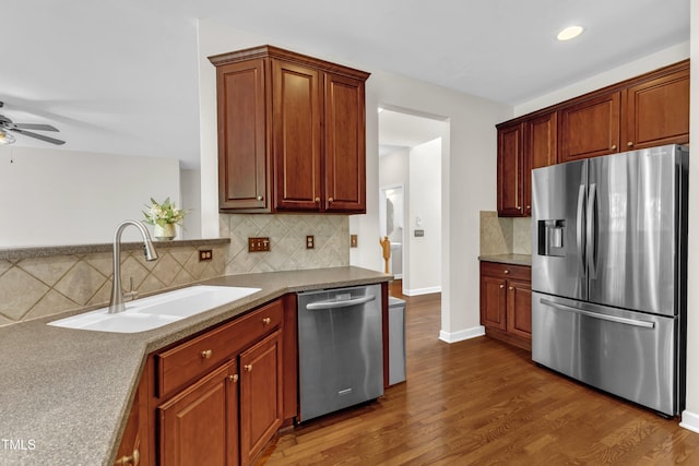 3905 Song Sparrow Dr, Wake Forest, NC 27587 - kitchen with stainless steel appliances, ceiling fan, decorative backsplash, wood finished floors, and recessed lighting