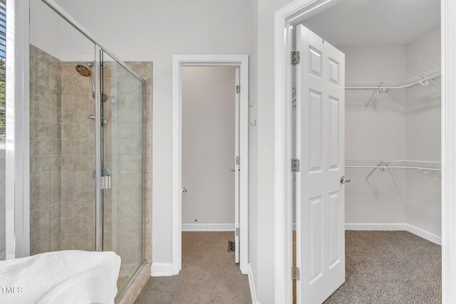 3905 Song Sparrow Dr, Wake Forest, NC 27587 - full bath featuring a shower stall, a walk in closet, and tile patterned flooring