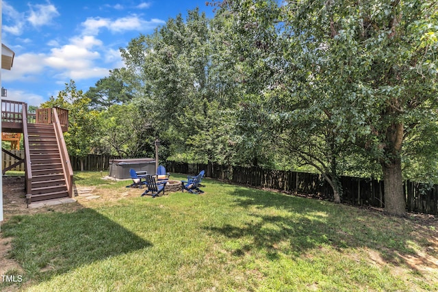 3905 Song Sparrow Dr, Wake Forest, NC 27587 - fenced backyard featuring a hot tub, stairs, a wooden deck, and a fire pit