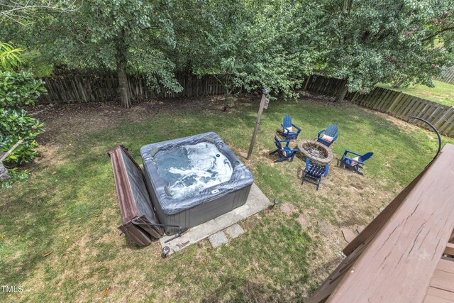 3905 Song Sparrow Dr, Wake Forest, NC 27587 - fenced backyard featuring a hot tub and an outdoor fire pit
