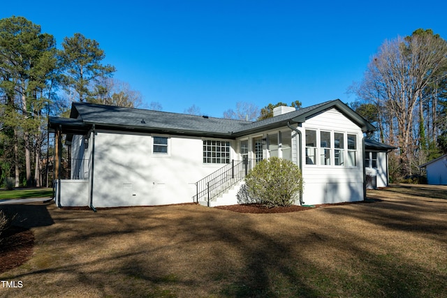 5920 Holly Dr, Raleigh, NC 27616 - back of house with a chimney, a yard, and a shingled roof