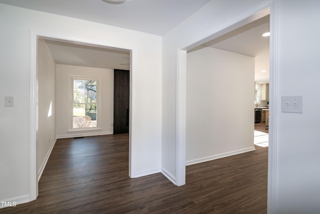 5920 Holly Dr, Raleigh, NC 27616 - hall featuring dark wood-type flooring and baseboards