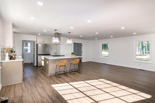 5920 Holly Dr, Raleigh, NC 27616 - kitchen featuring freestanding refrigerator, recessed lighting, dark wood-type flooring, a kitchen island, and light countertops