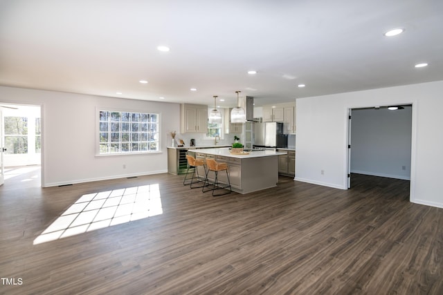 5920 Holly Dr, Raleigh, NC 27616 - kitchen with open floor plan, a kitchen island, recessed lighting, dark wood-style flooring, and freestanding refrigerator