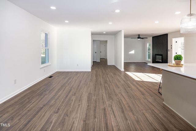 5920 Holly Dr, Raleigh, NC 27616 - unfurnished living room with a fireplace, dark wood finished floors, recessed lighting, and a ceiling fan