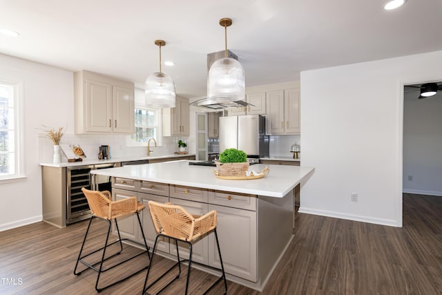 5920 Holly Dr, Raleigh, NC 27616 - kitchen featuring freestanding refrigerator, beverage cooler, a kitchen breakfast bar, light countertops, and decorative backsplash