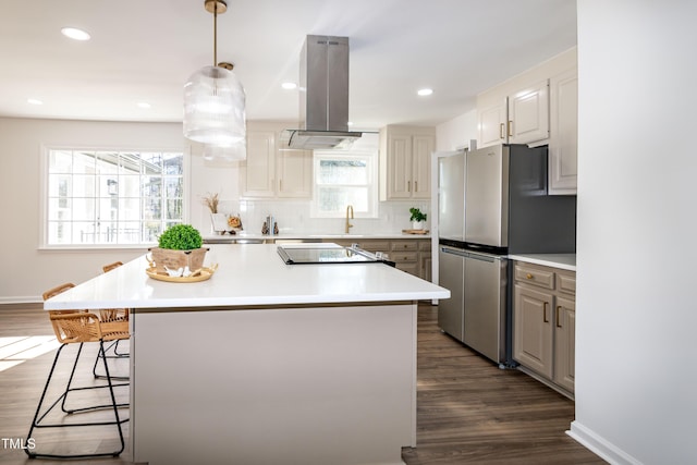 5920 Holly Dr, Raleigh, NC 27616 - kitchen featuring ventilation hood, freestanding refrigerator, dark wood-style floors, a center island, and light countertops